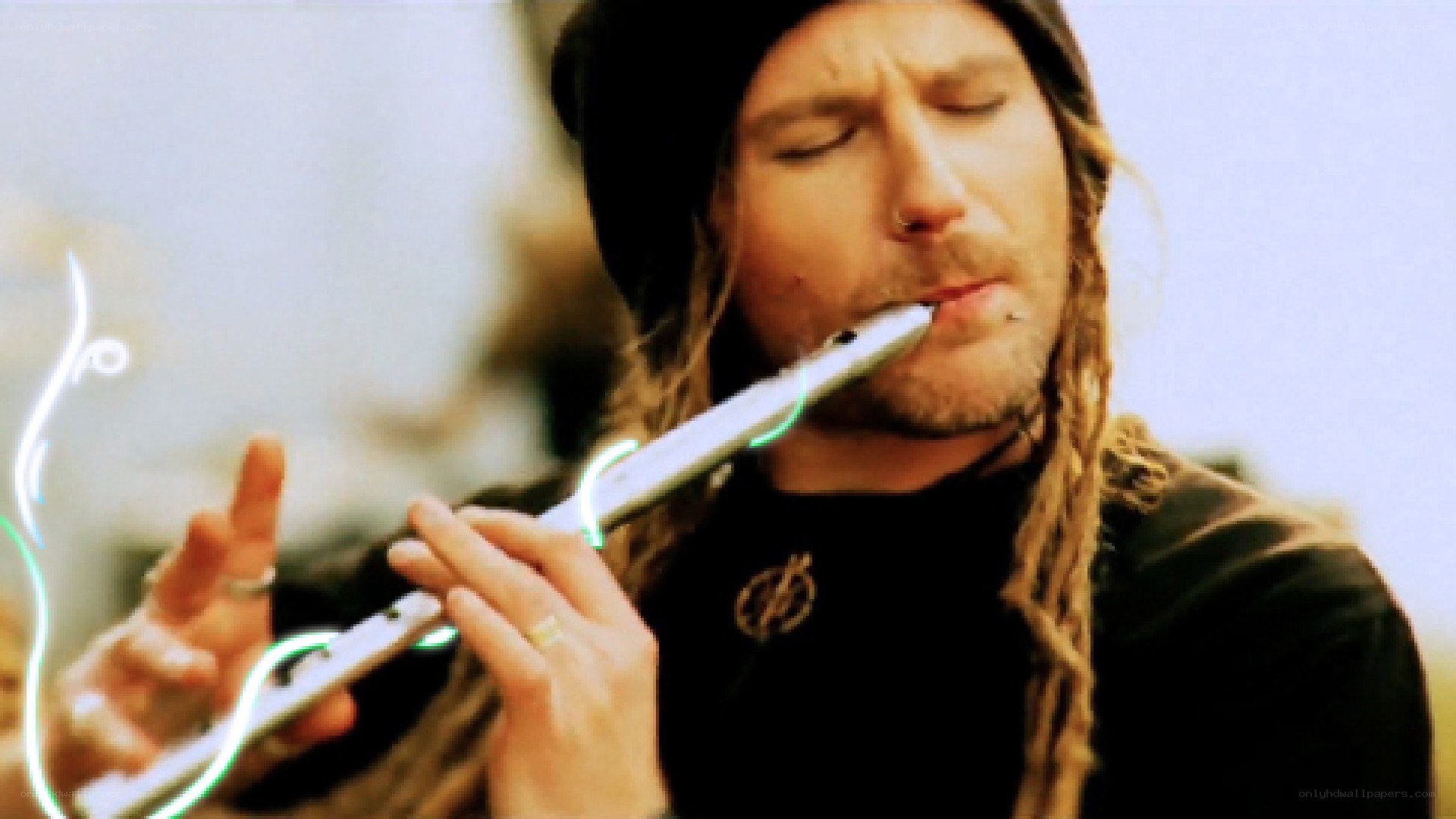 man playing flute outdoors
