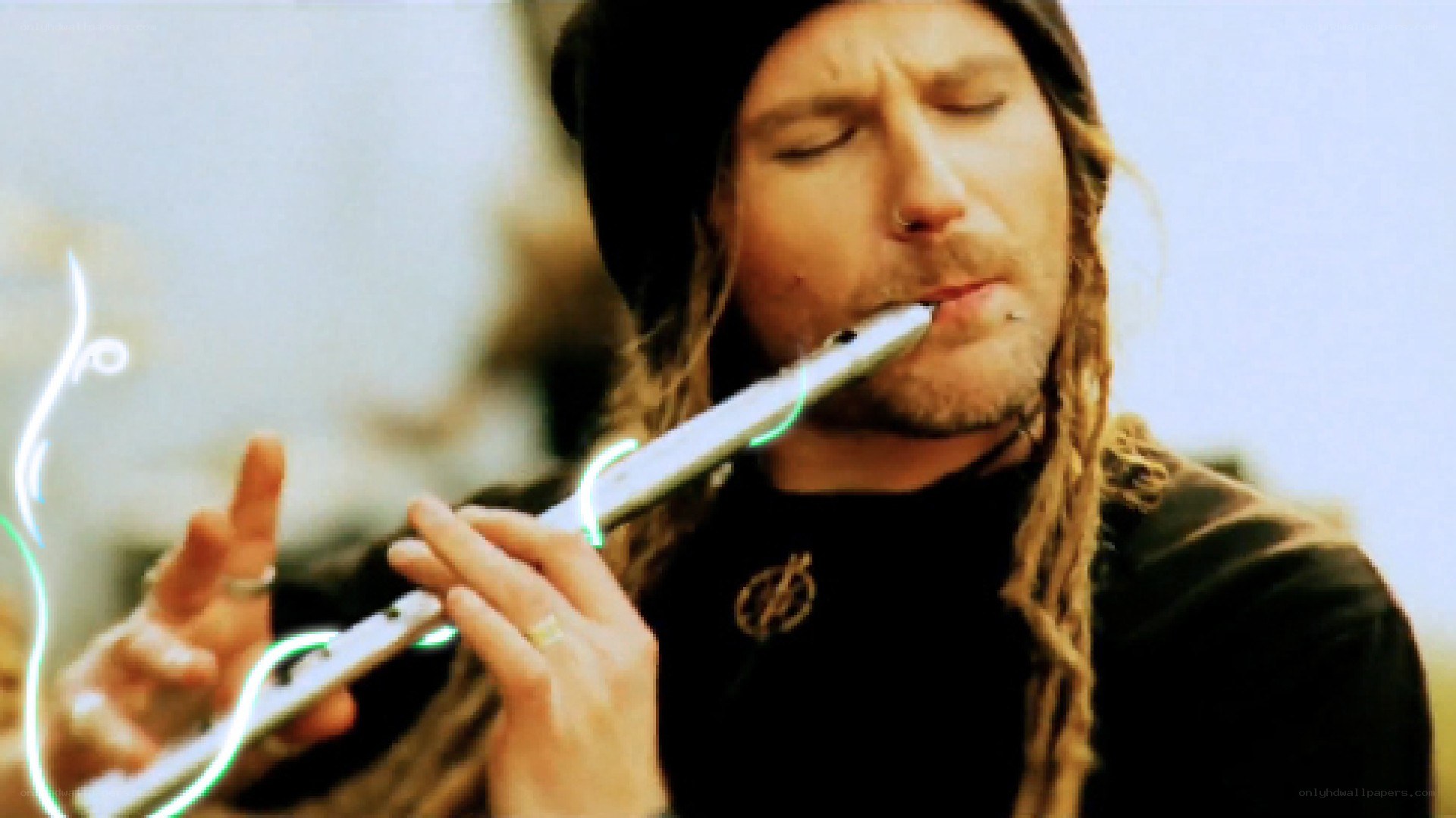 man playing flute outdoors
