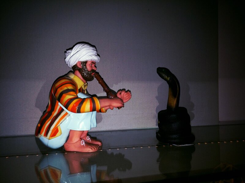 Man Playing Flute with Snake