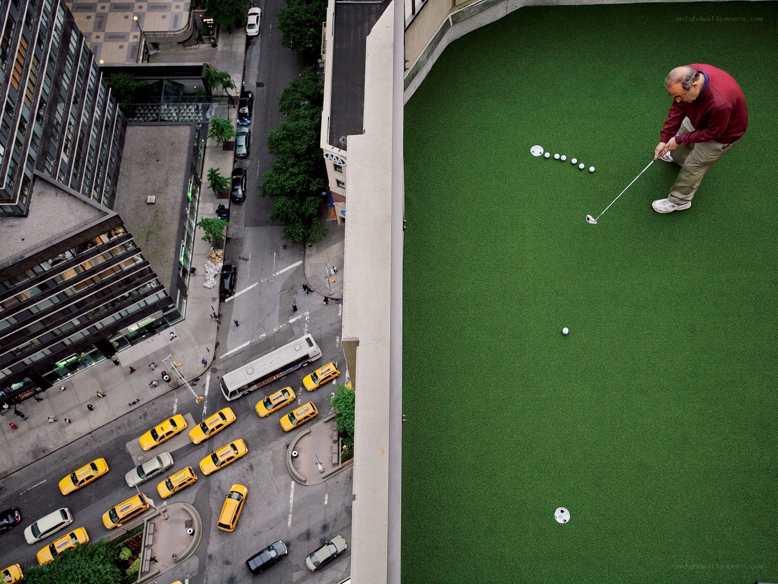 Man playing golf on rooftop
