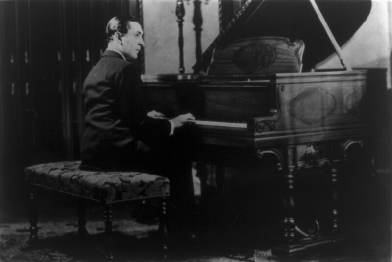 man playing grand piano