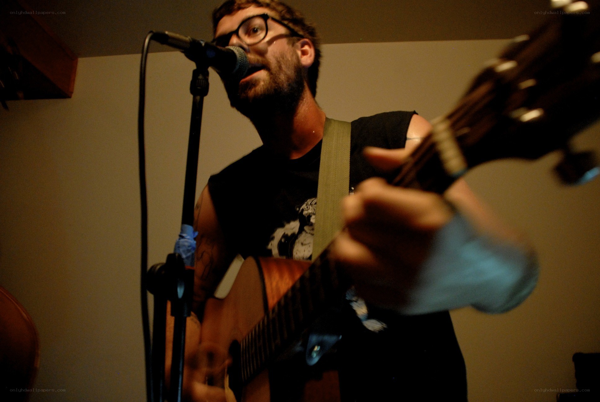 man playing guitar and singing