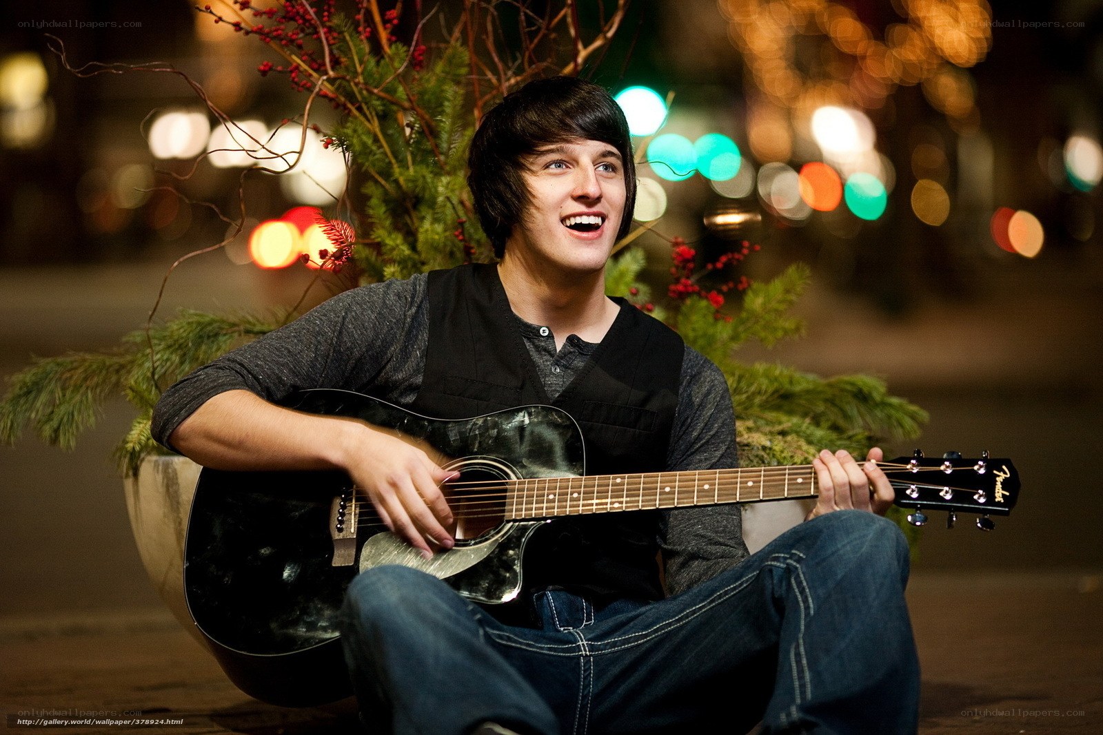 man playing guitar at night