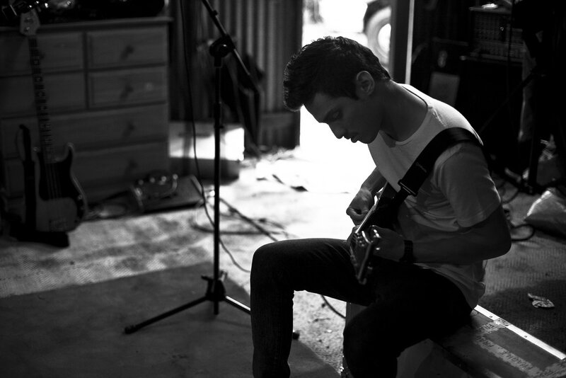 man playing guitar in garage