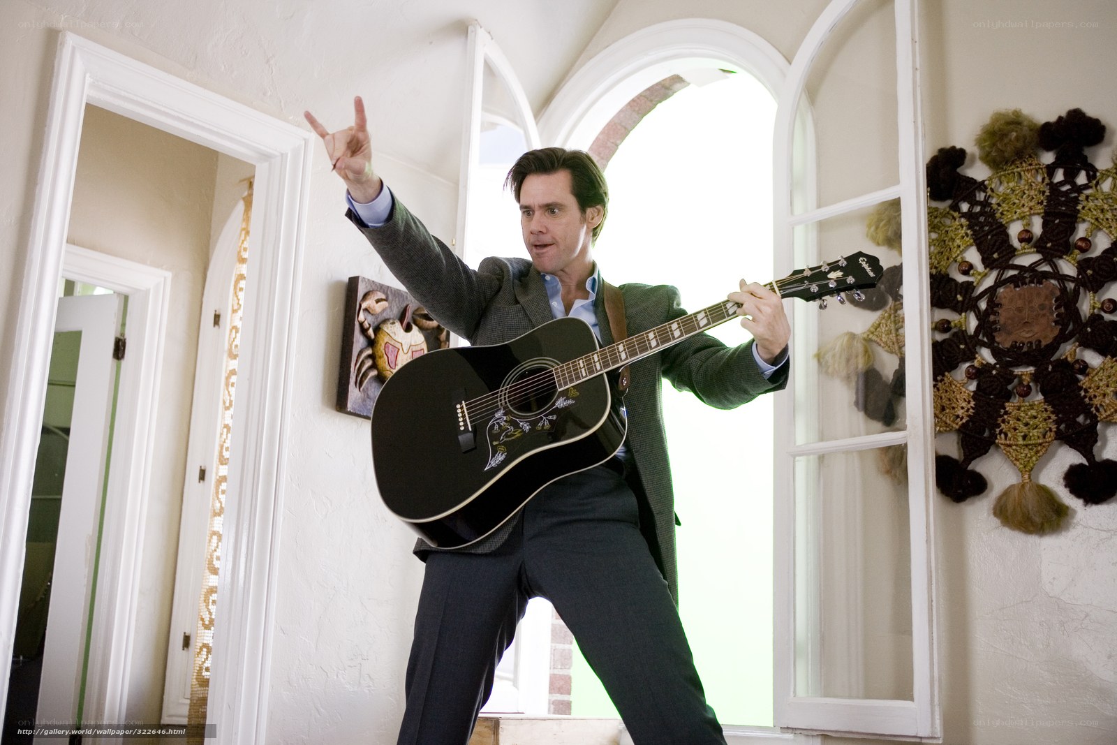 Man playing guitar in hallway