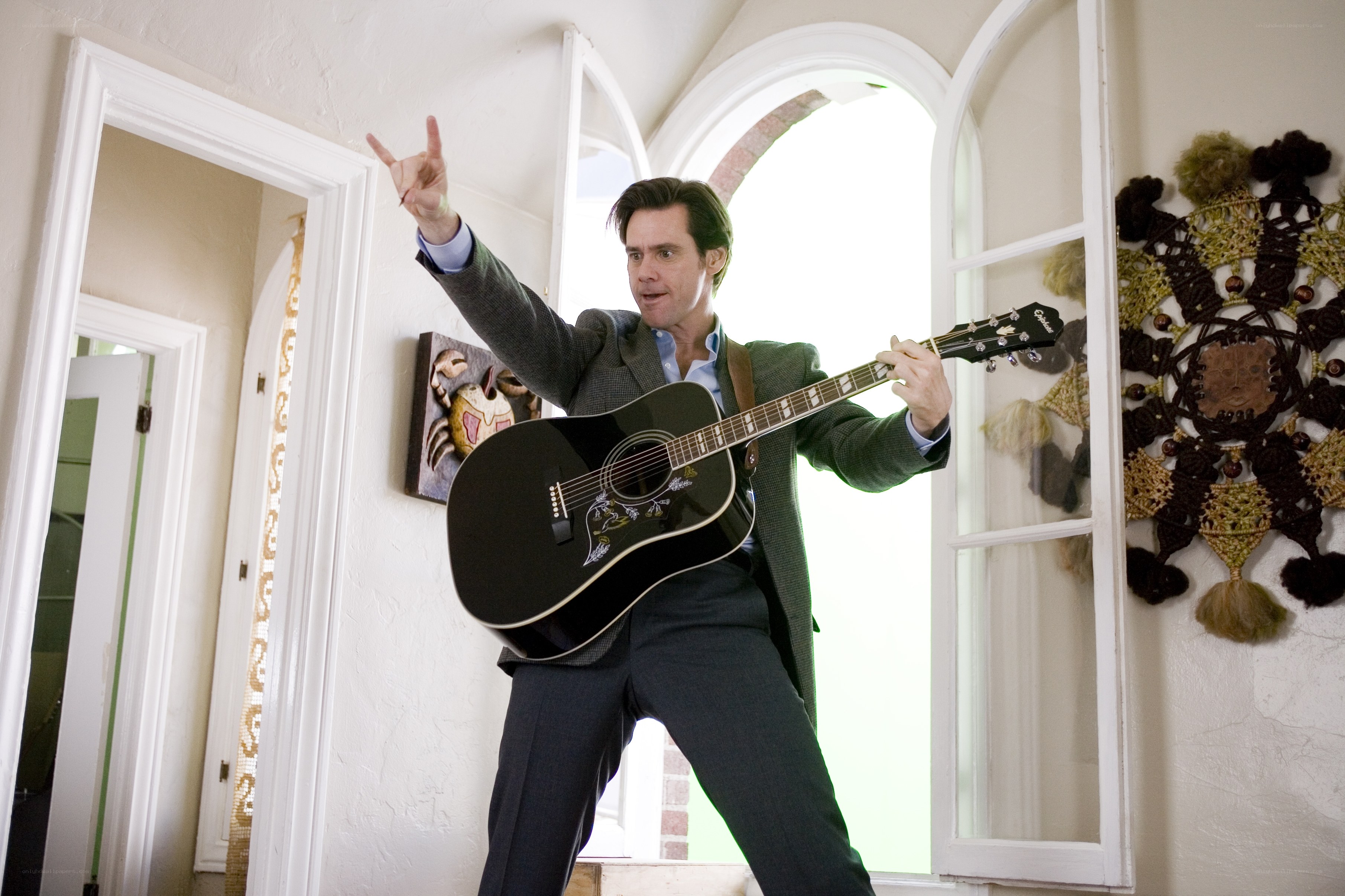Man playing guitar in house