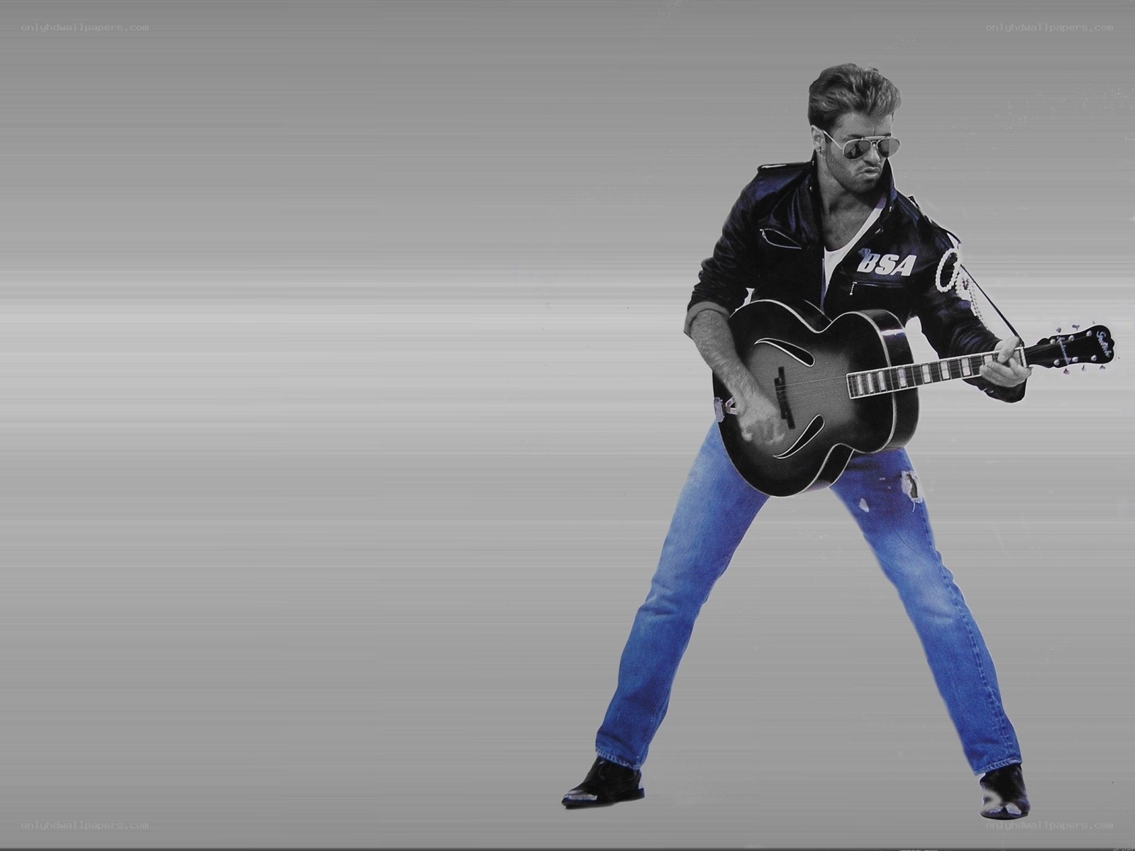 Man playing guitar in leather jacket