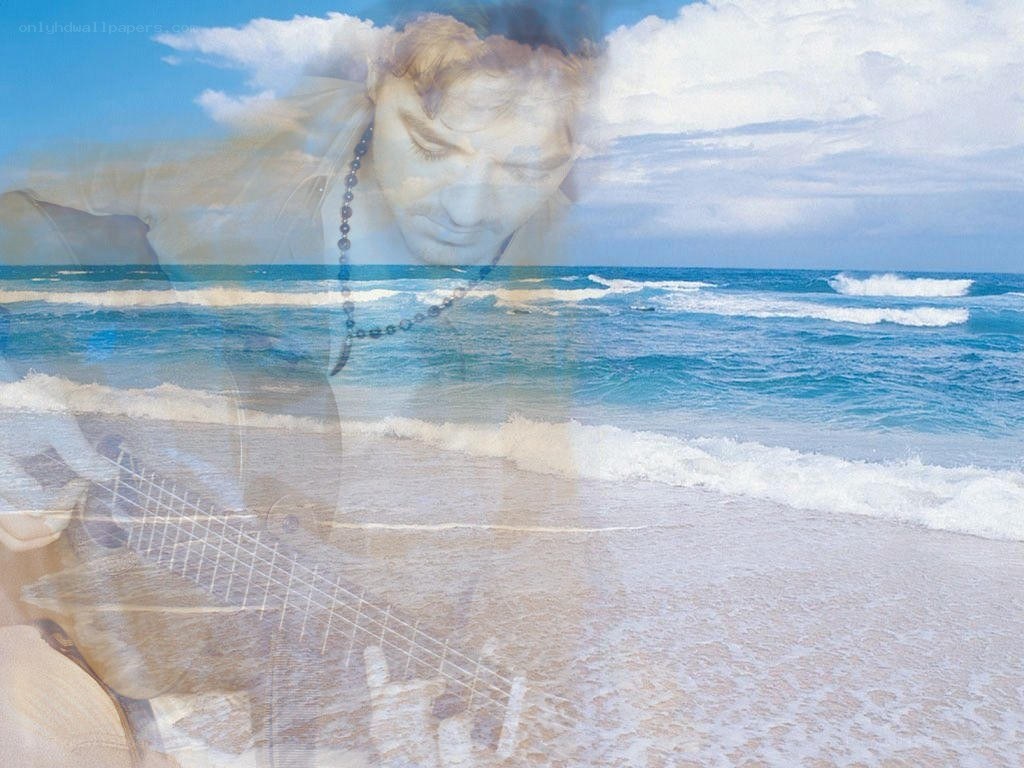 Man playing guitar on beach