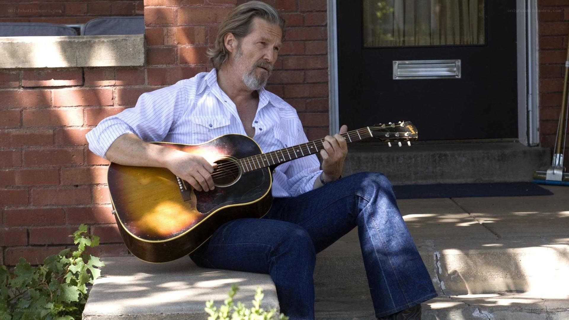 man playing guitar on porch