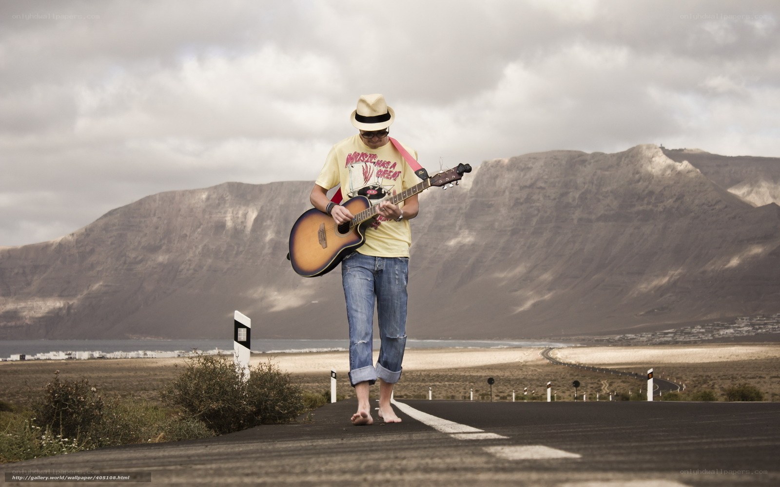 Man playing guitar on road