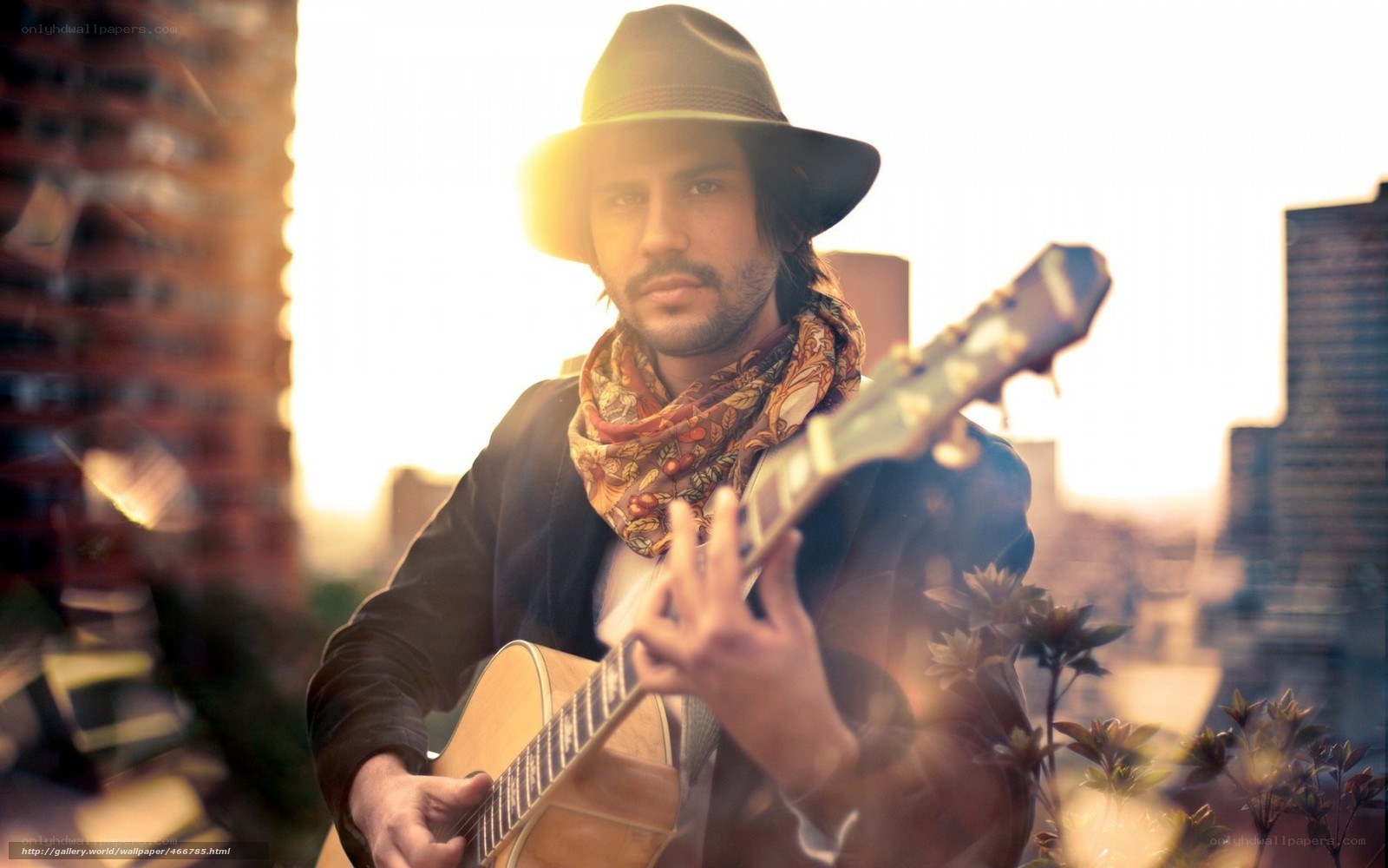 man playing guitar on rooftop
