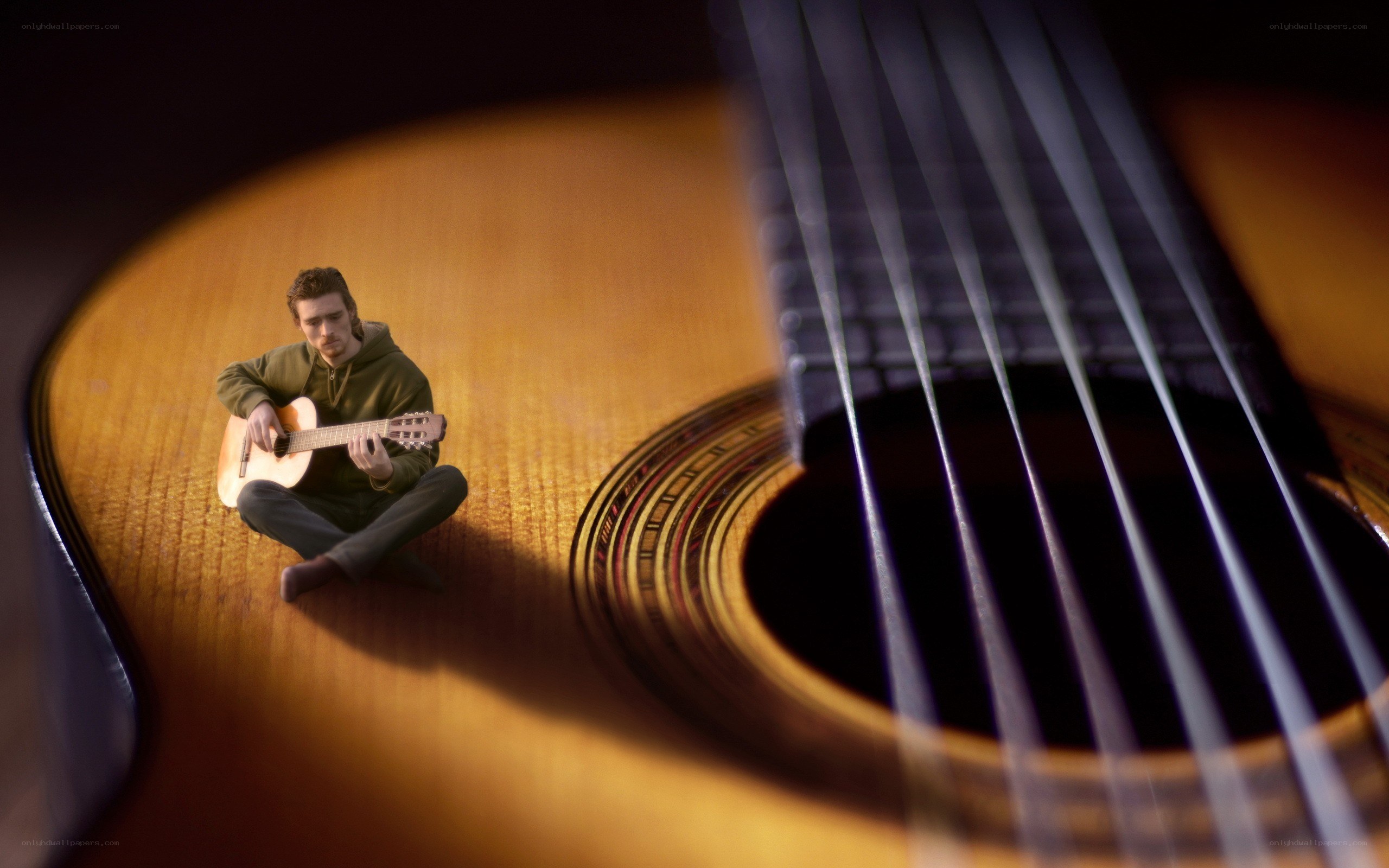 Man playing guitar on soundboard