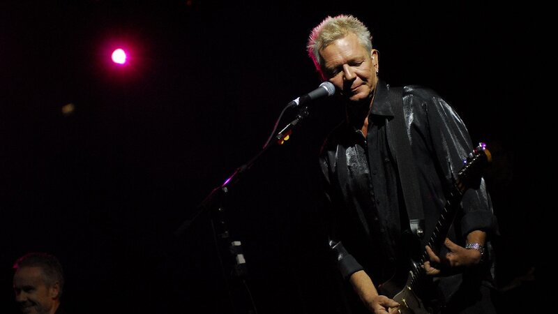 Man Playing Guitar on Stage — Black, Dramatic, Night, Photograph, Microphone, Stage Light