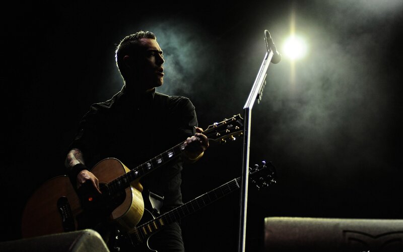 Man Playing Guitar on Stage — Black, Dramatic, Night, Photograph, Microphone Stand