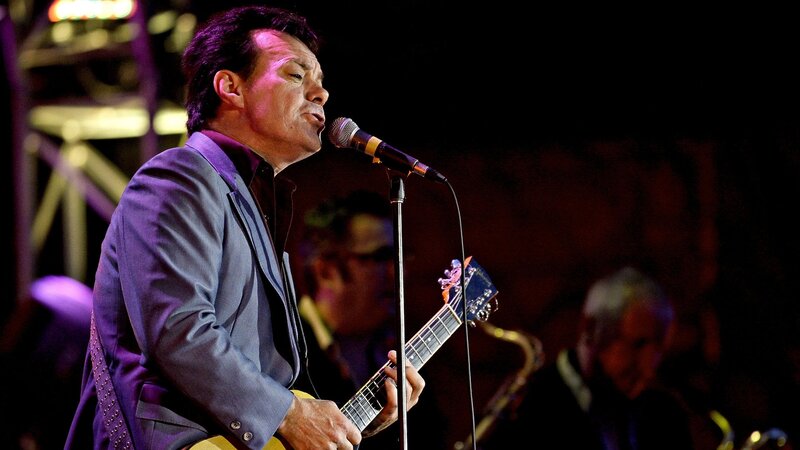 Man Playing Guitar on Stage — Purple