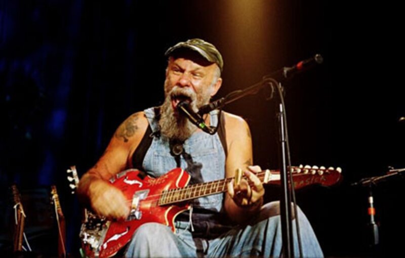 Man Playing Guitar on Stage — Red