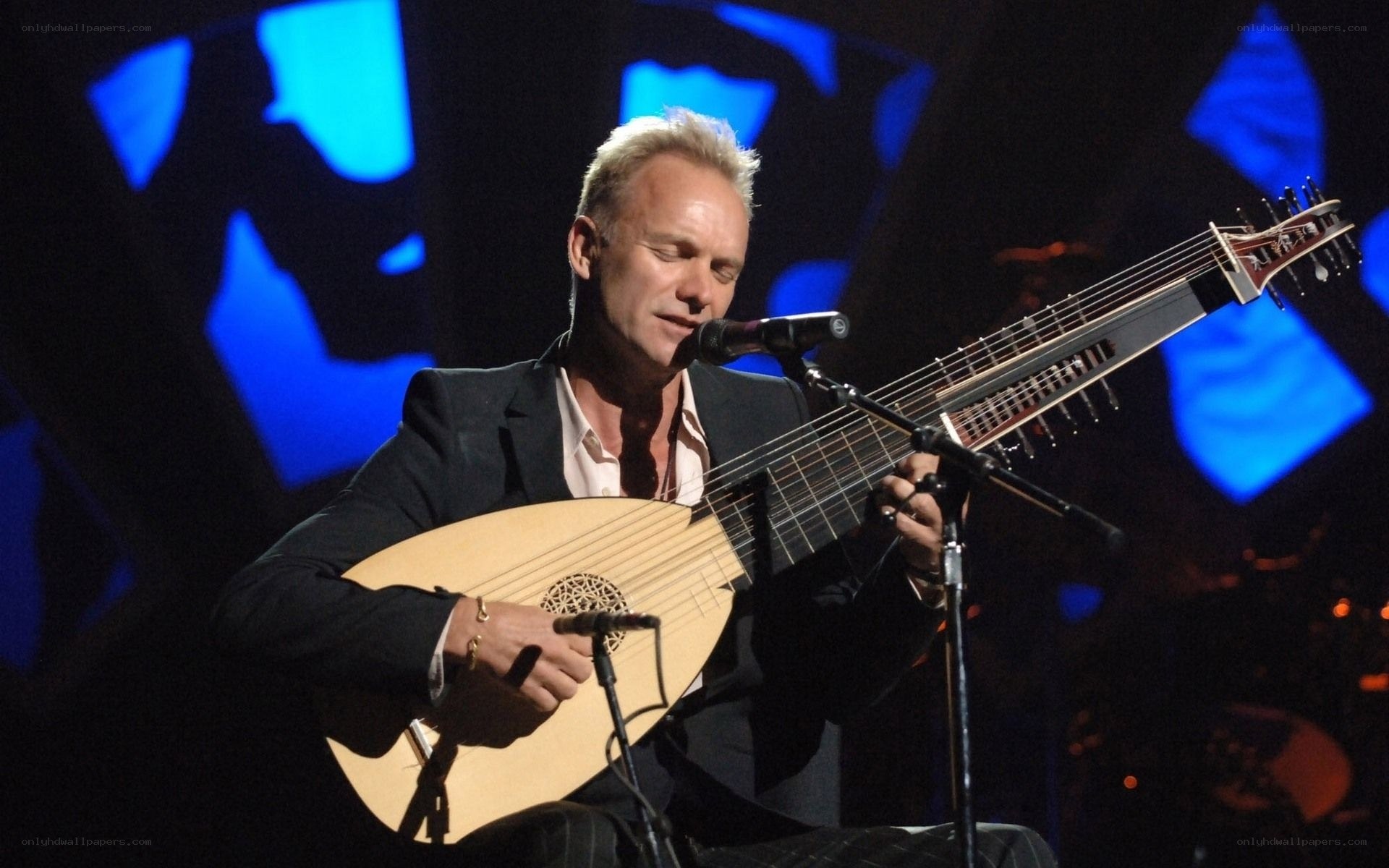 man playing lute on stage