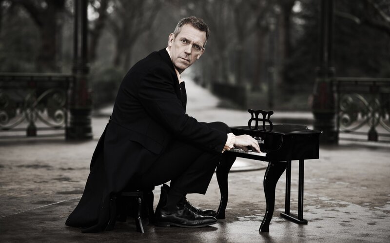 man playing miniature piano