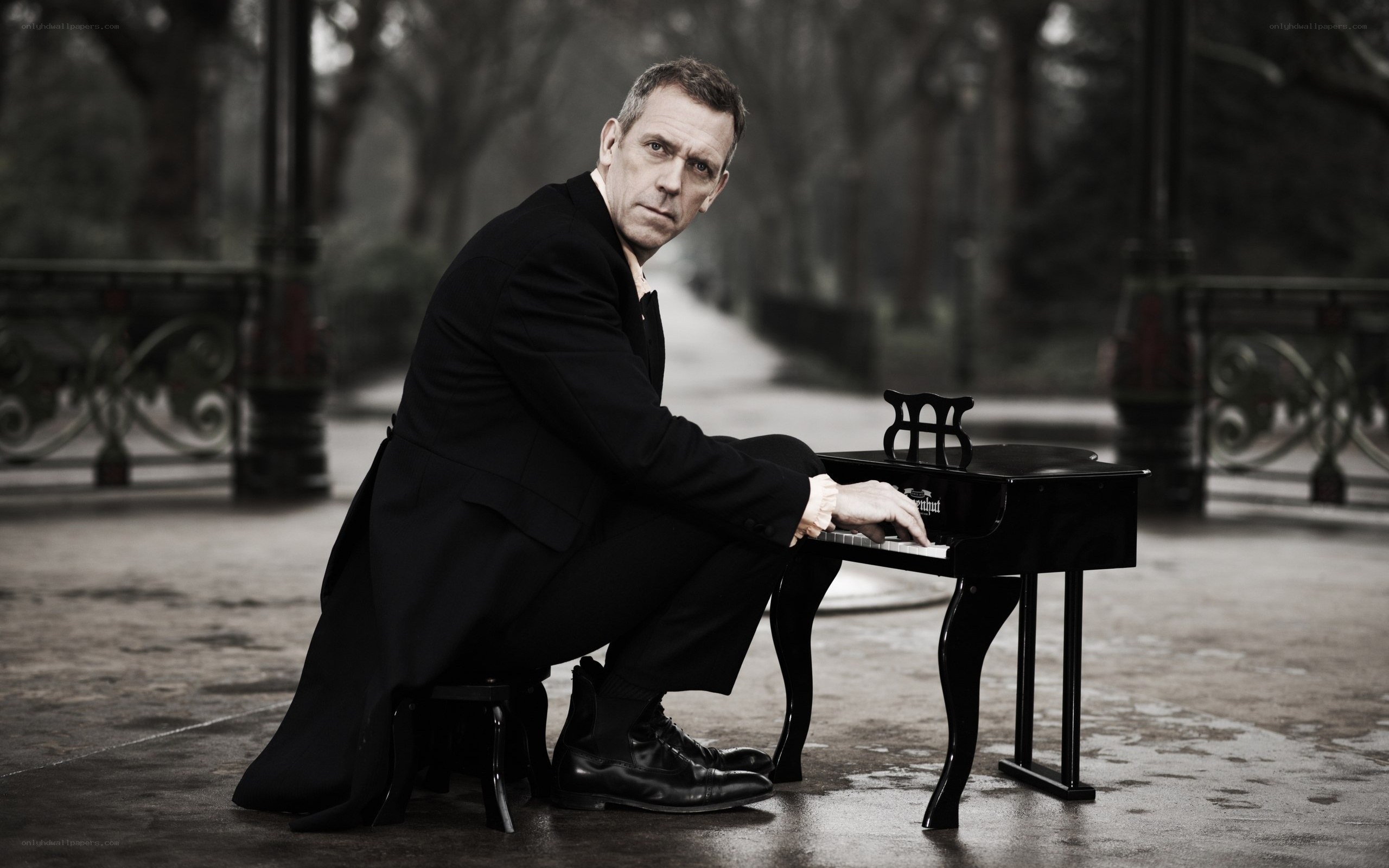 man playing miniature piano