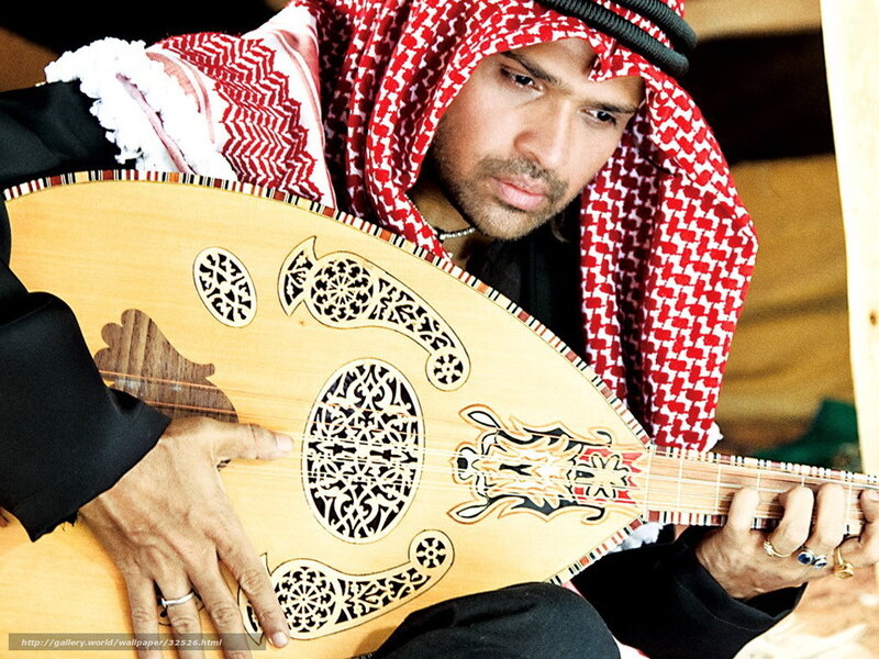 man playing oud instrument
