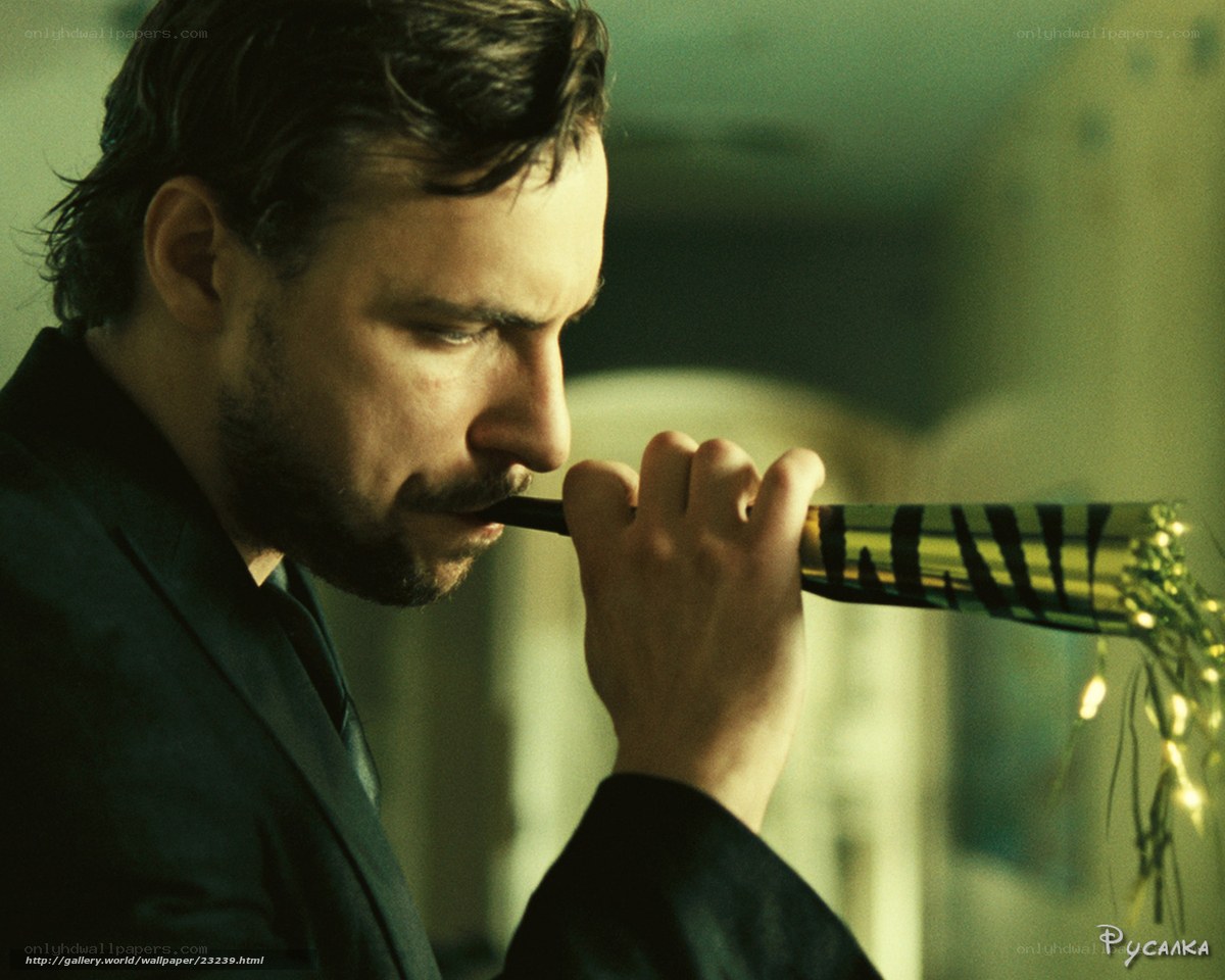 man playing party horn