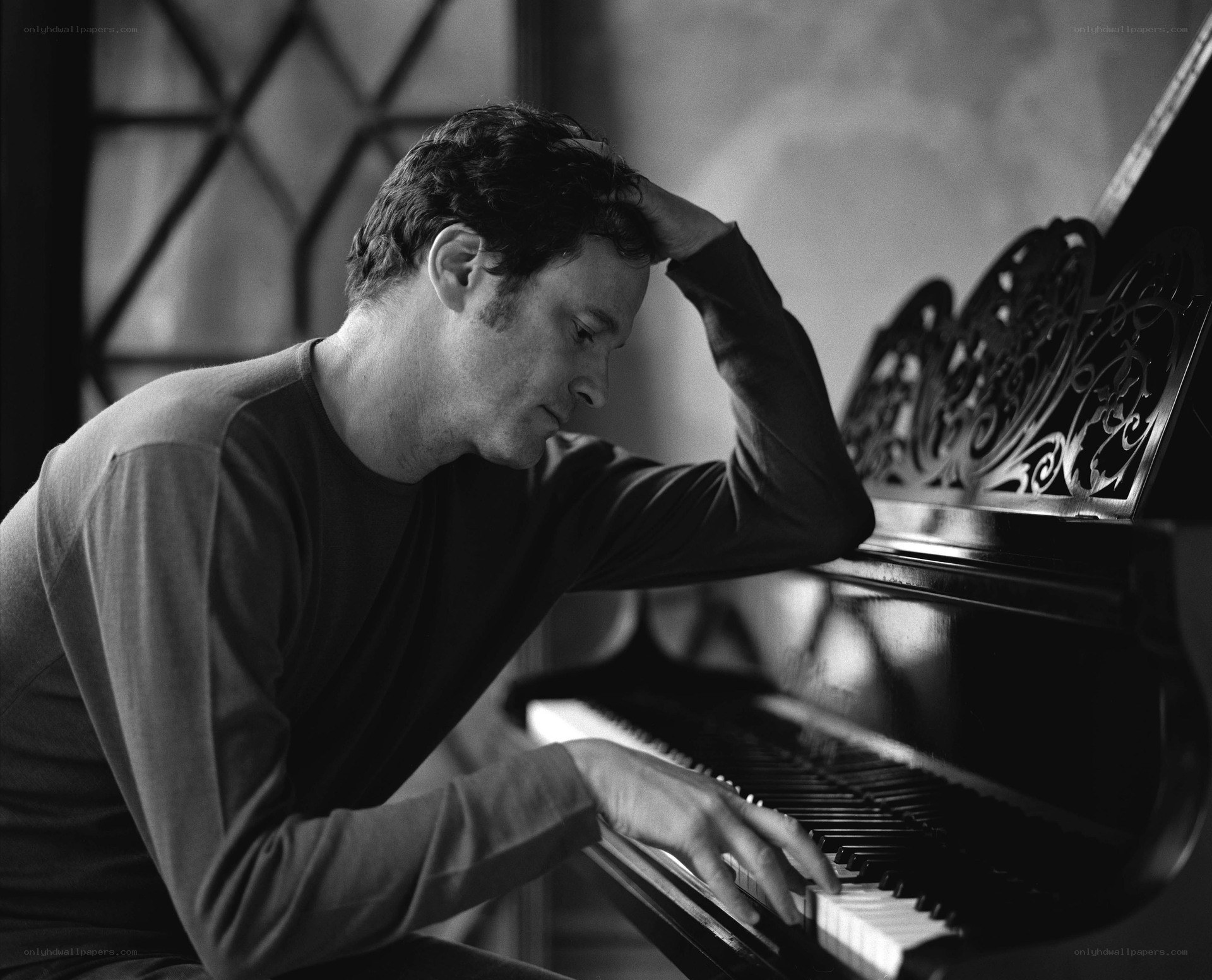 man playing piano in contemplation