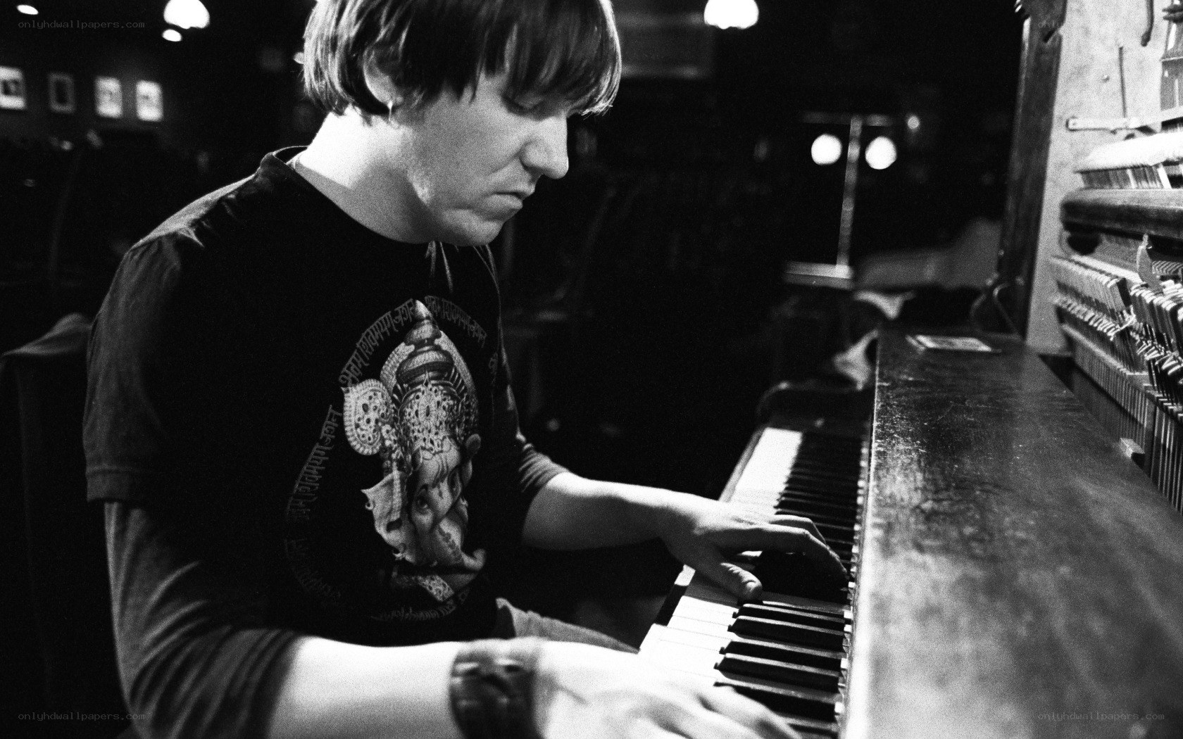 man playing piano in dim light