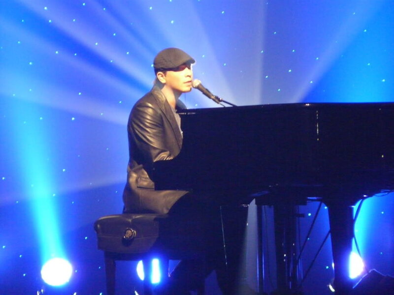 Man Playing Piano on Stage — Blue