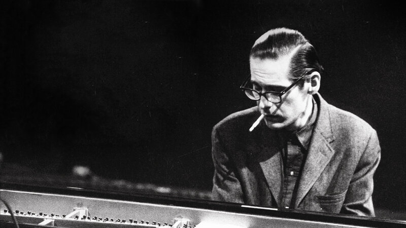 man playing piano with cigarette