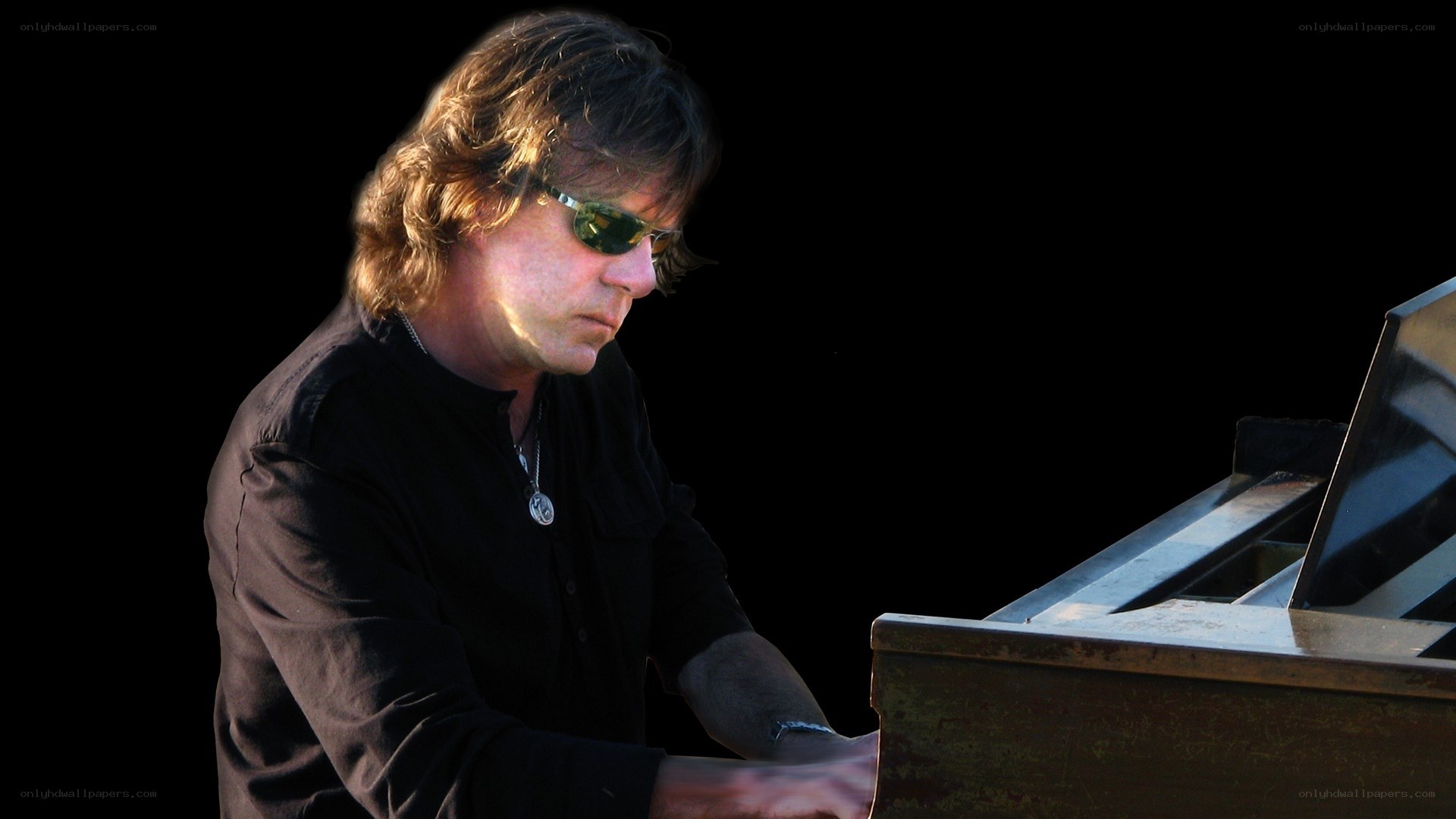 man playing piano with sunglasses