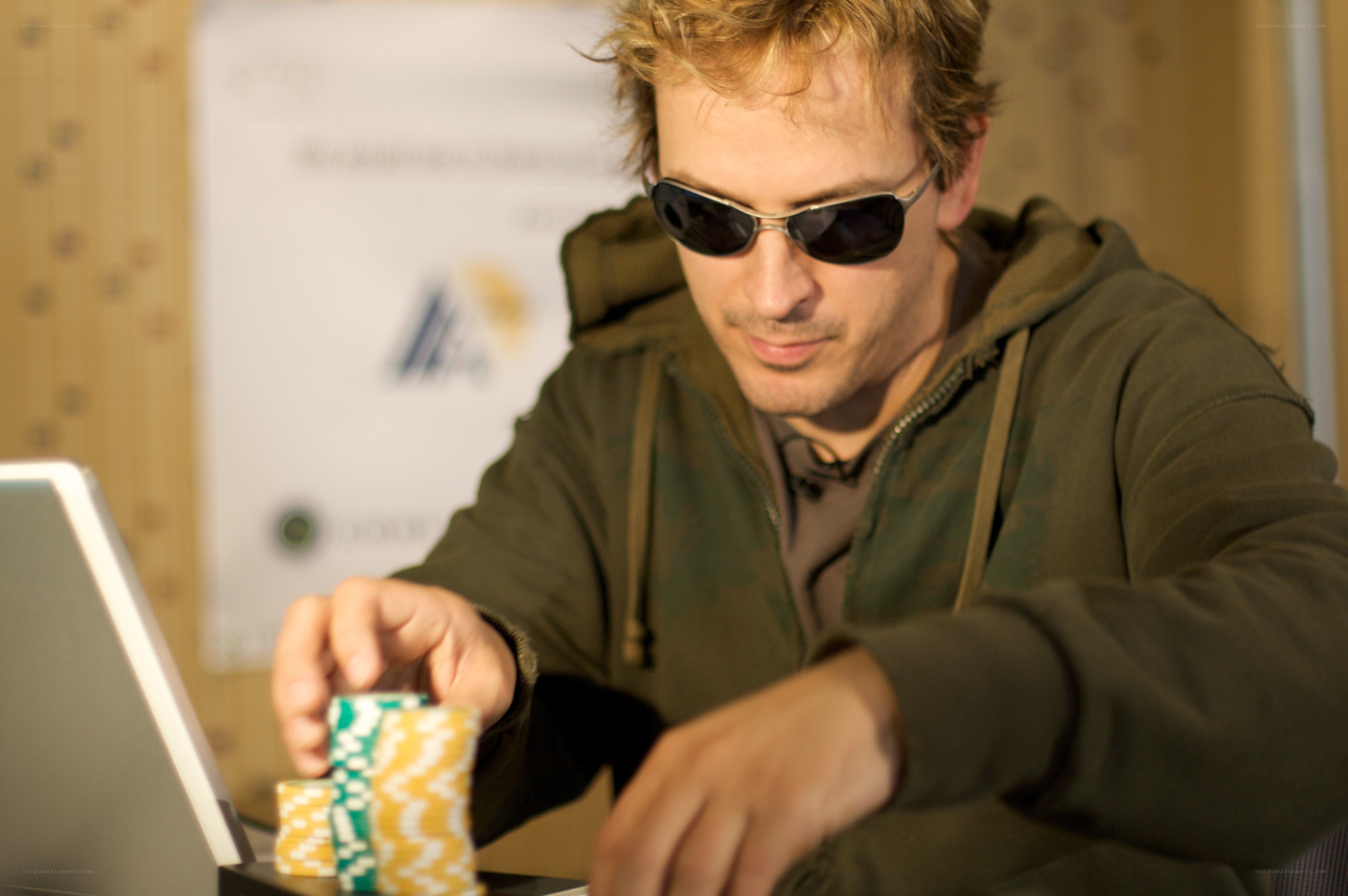 man playing poker with laptop