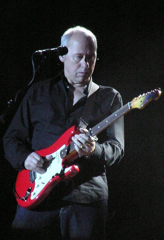 Man playing red electric guitar