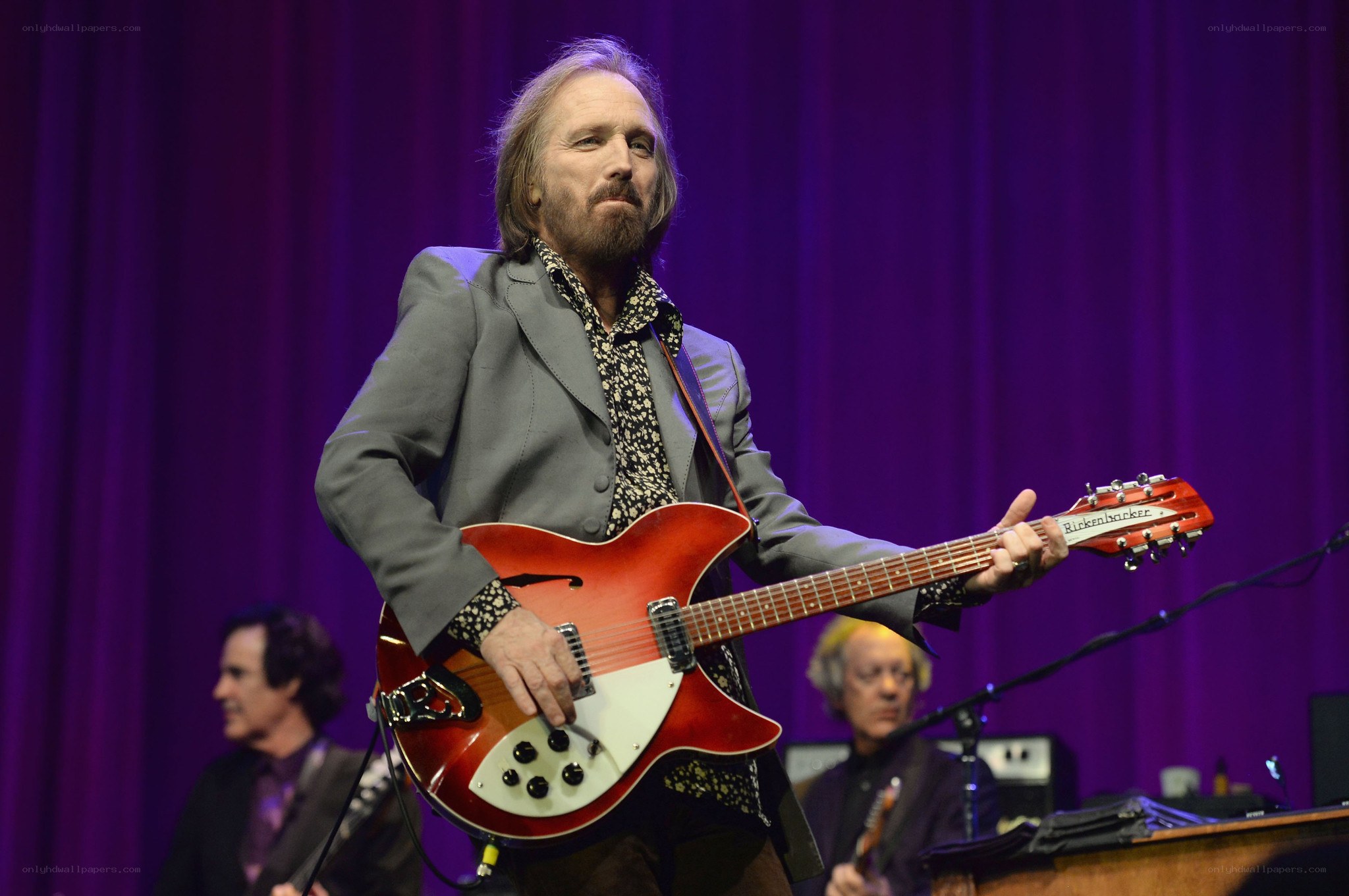 Man playing red guitar on stage