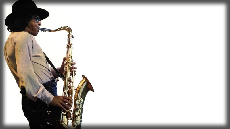 Man Playing Saxophone — Black, Focused, Photograph, Hat