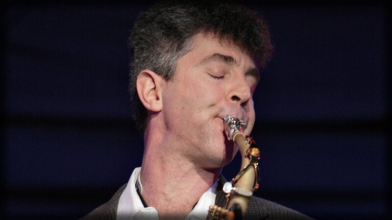 Man Playing Saxophone — Black, Focused