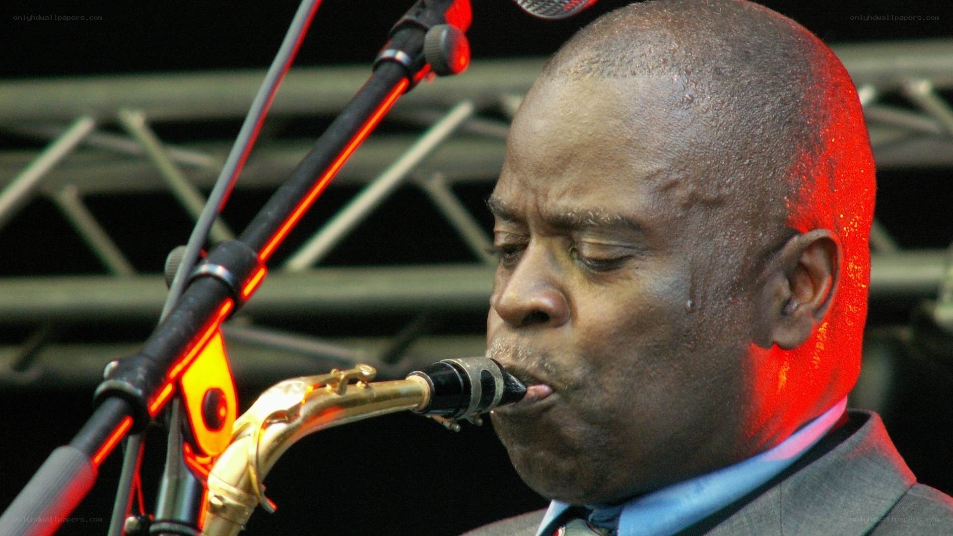 man playing saxophone on stage