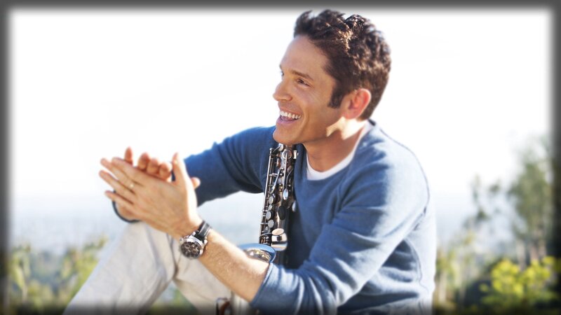 man playing saxophone outdoors