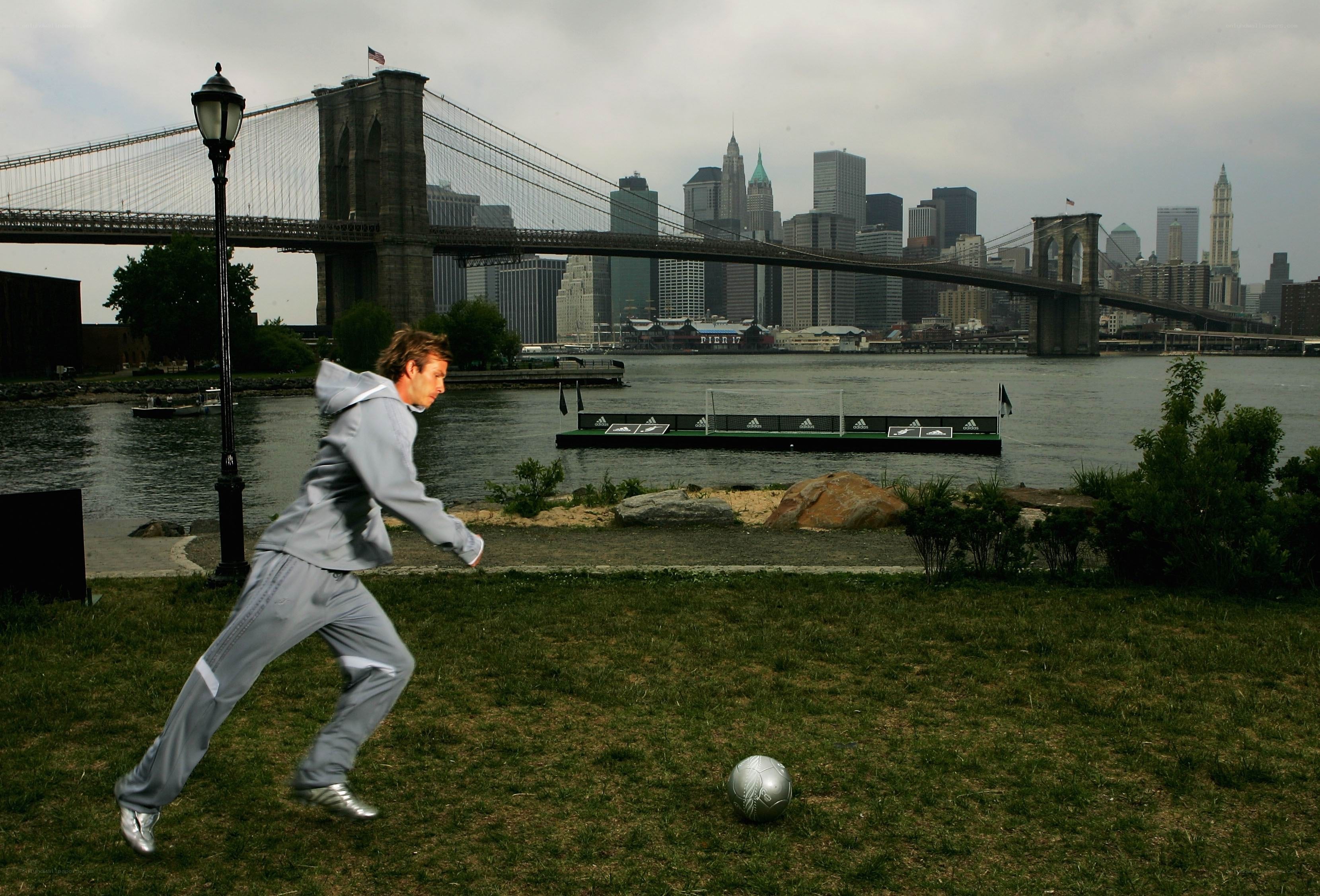 Man playing soccer by the river