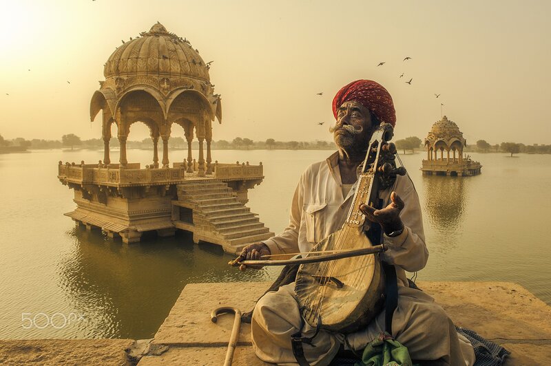 Man Playing String Instrument — Gold