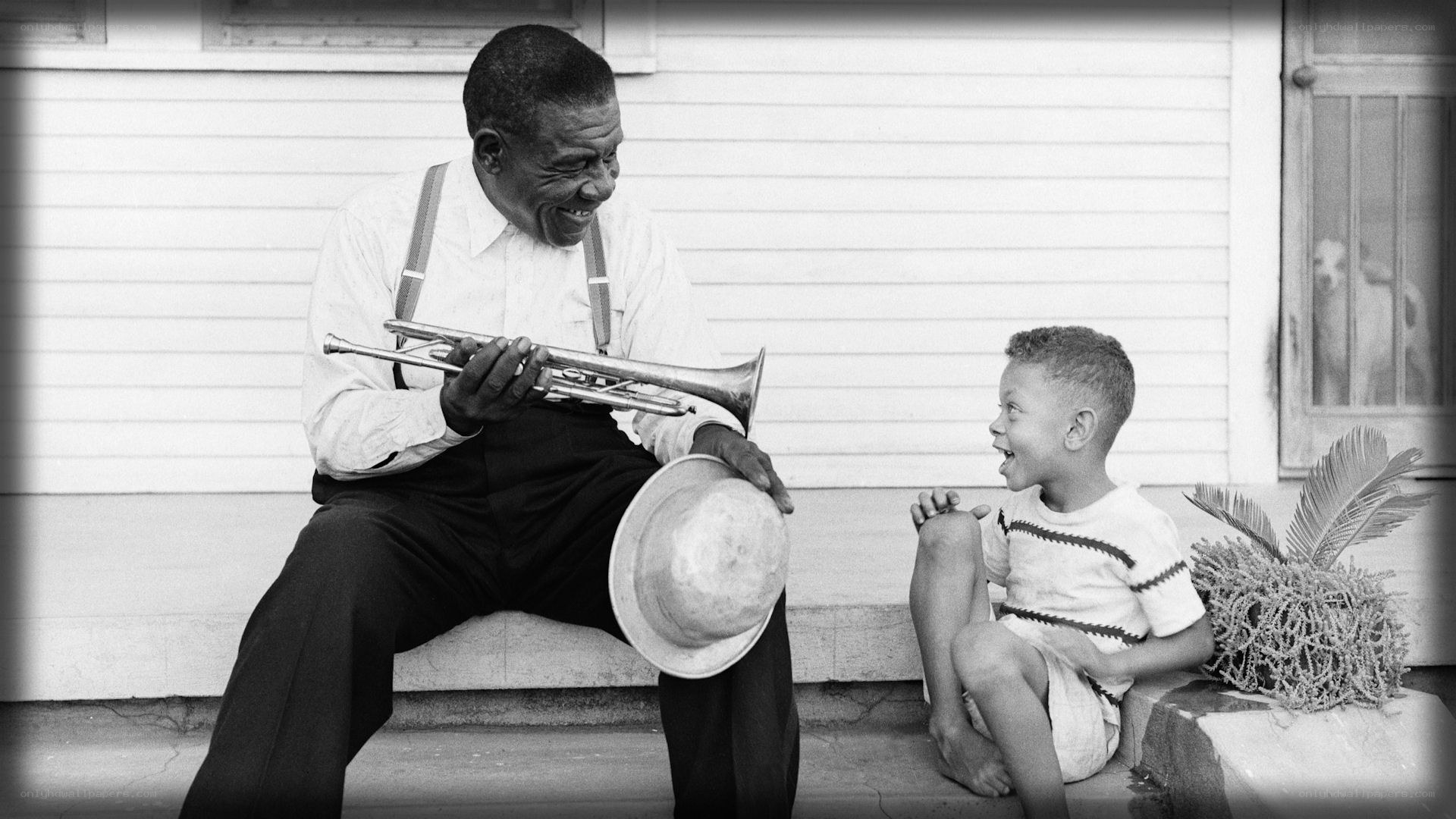 Man playing trumpet for child