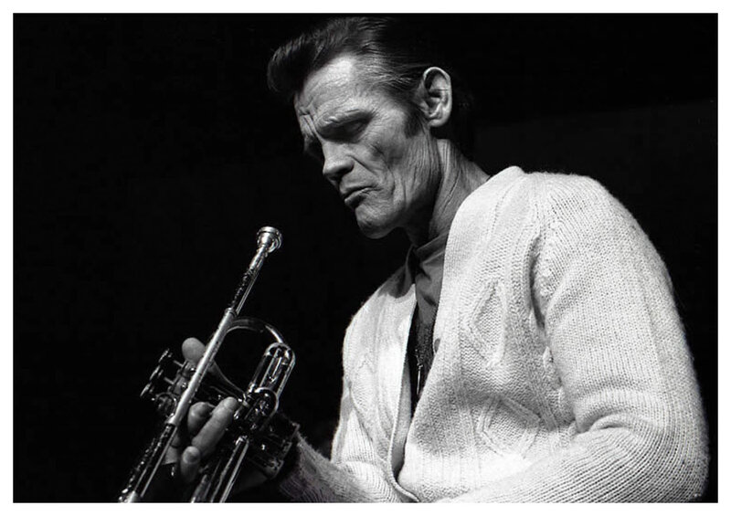 man playing trumpet in black and white