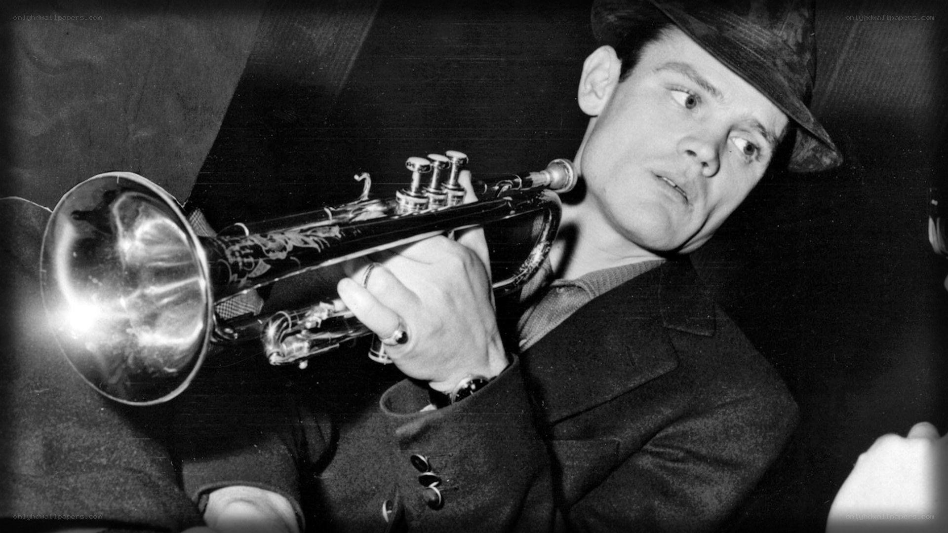 man playing trumpet in hat