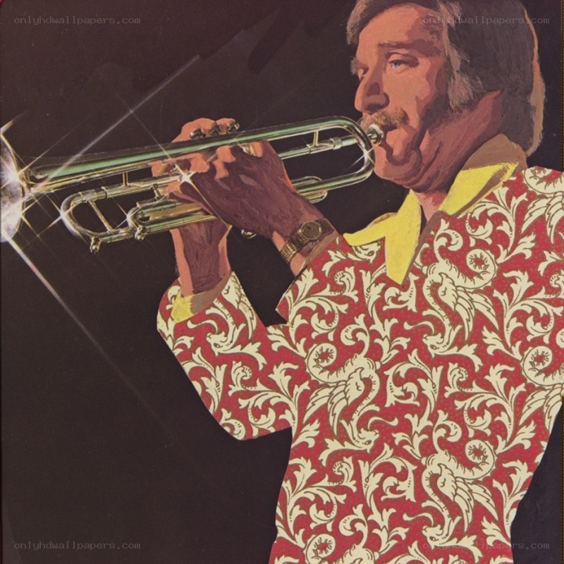 man playing trumpet in patterned shirt