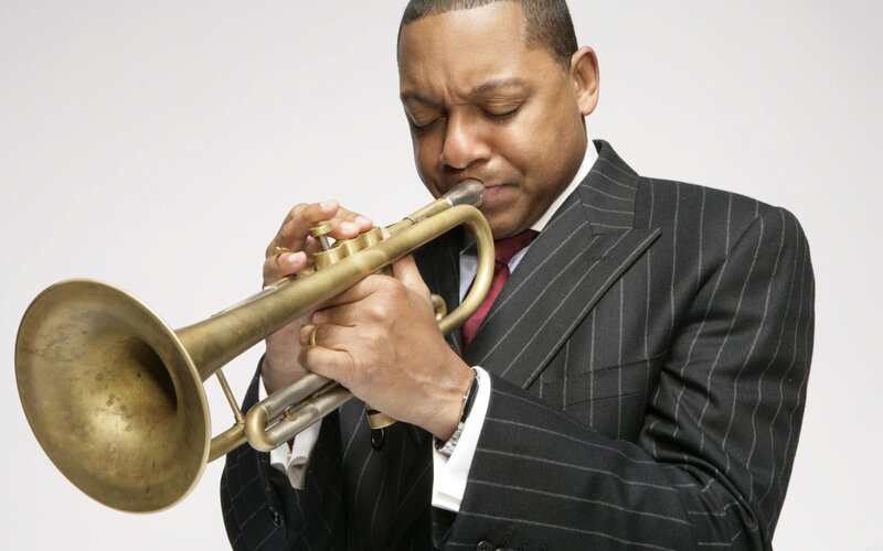 Man playing trumpet in suit