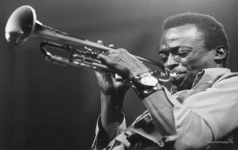 man playing trumpet on stage