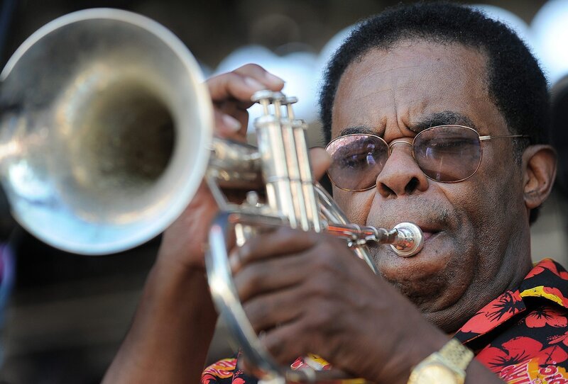 Man playing trumpet outdoors