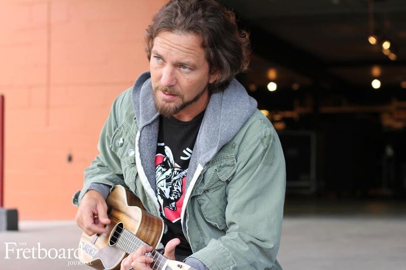 man playing ukulele