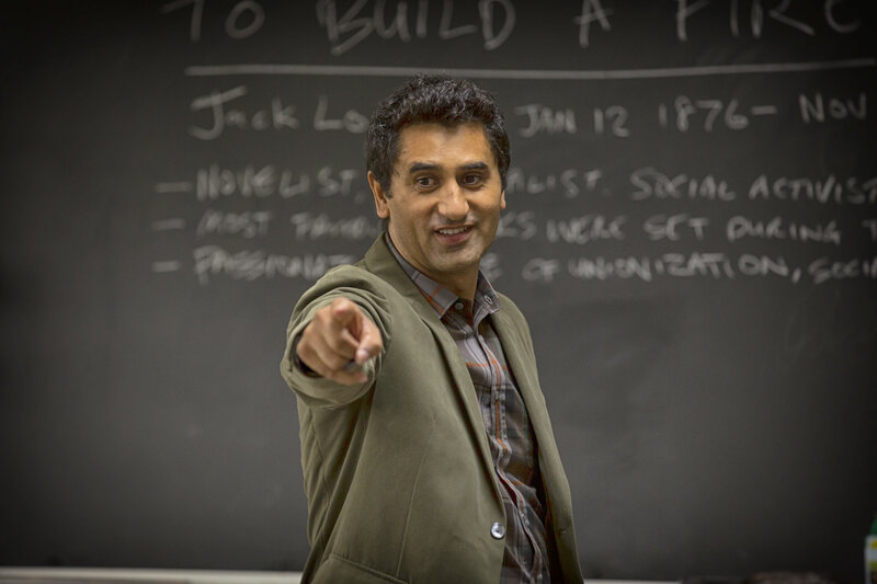 man pointing at camera in classroom