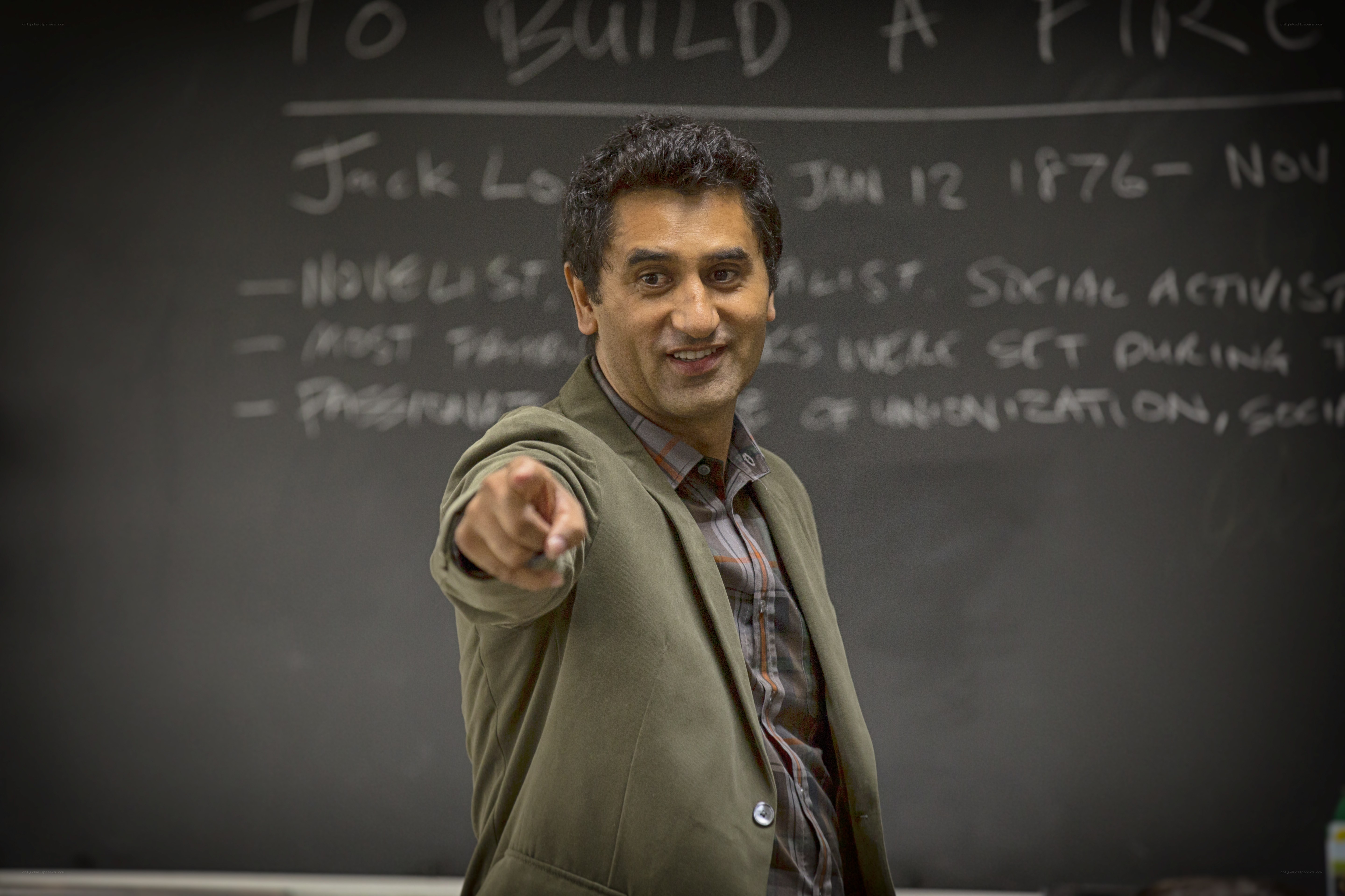 man pointing at camera in classroom