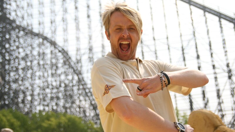 man pointing at roller coaster